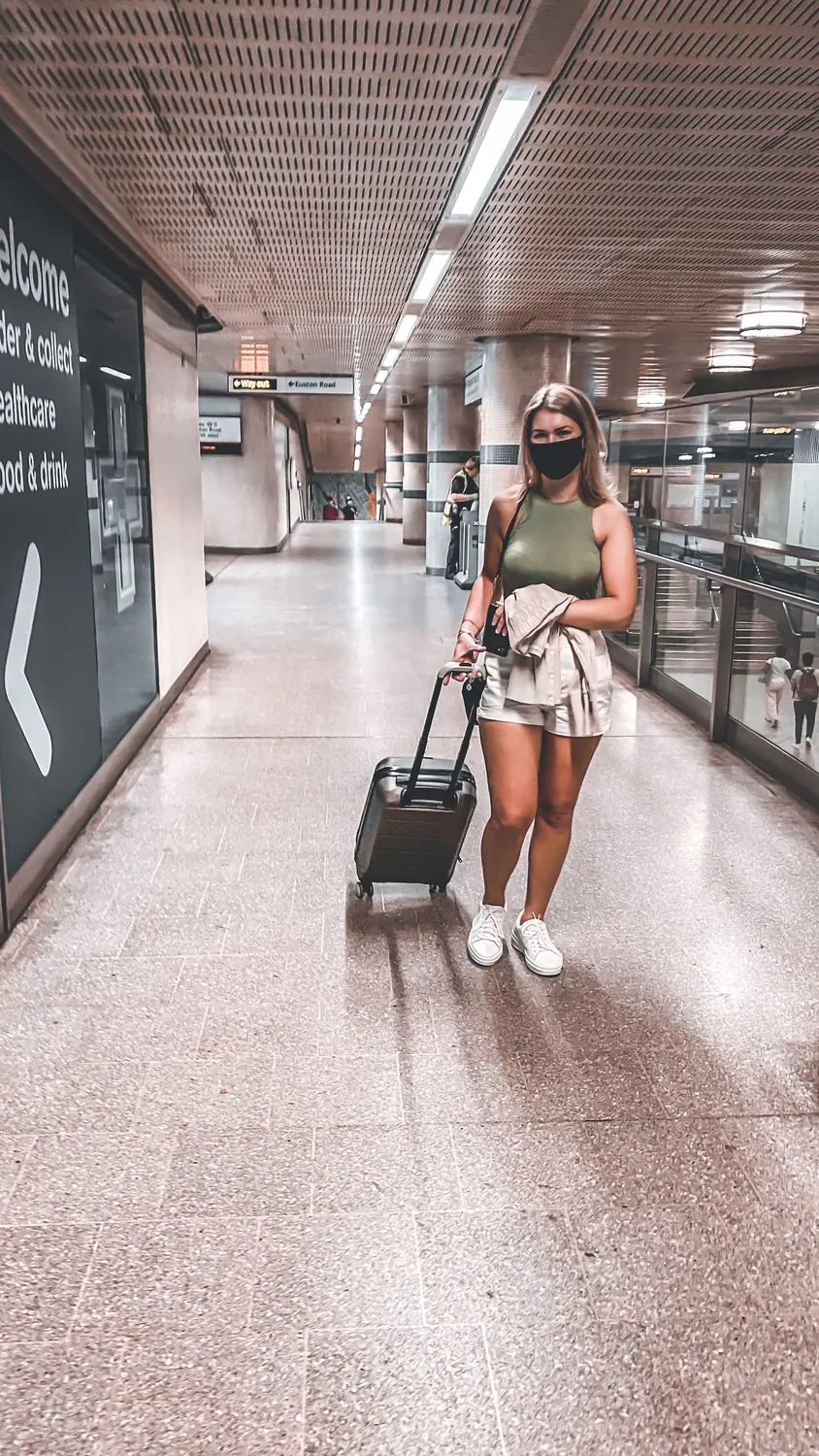 Traveler walking through an airport with luggage