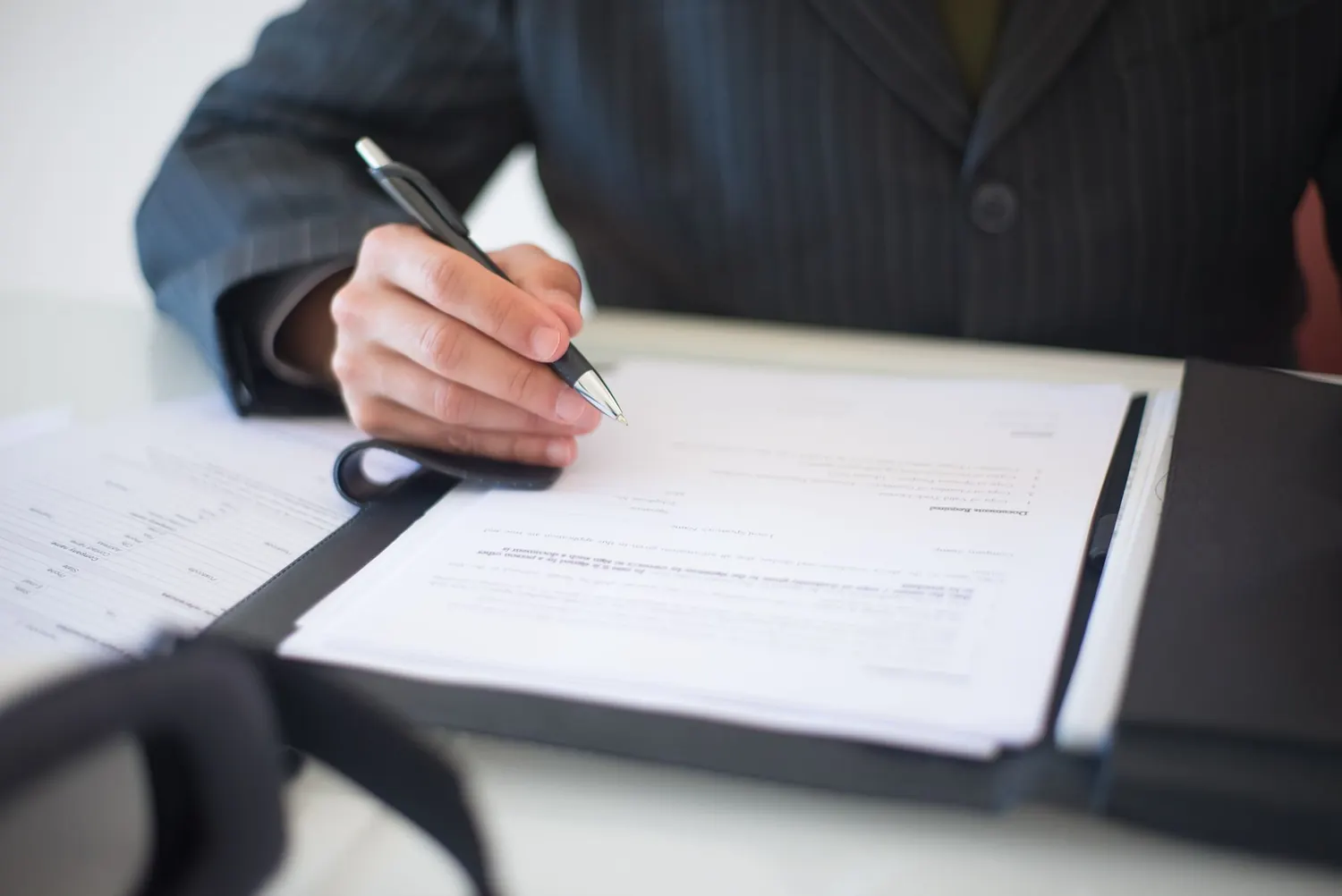 Business contract being signed with a pen