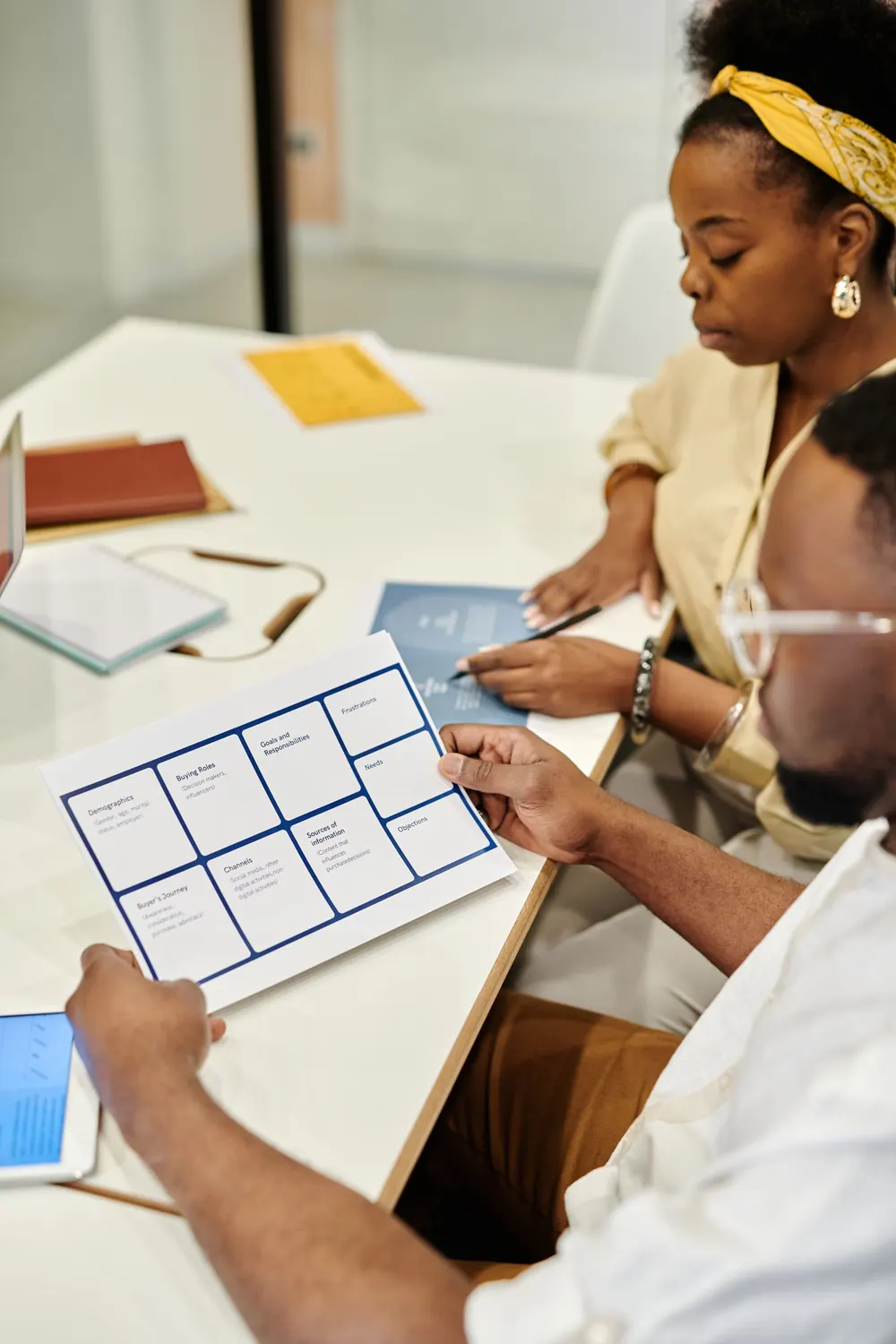 Colleagues aligning documents in a business meeting