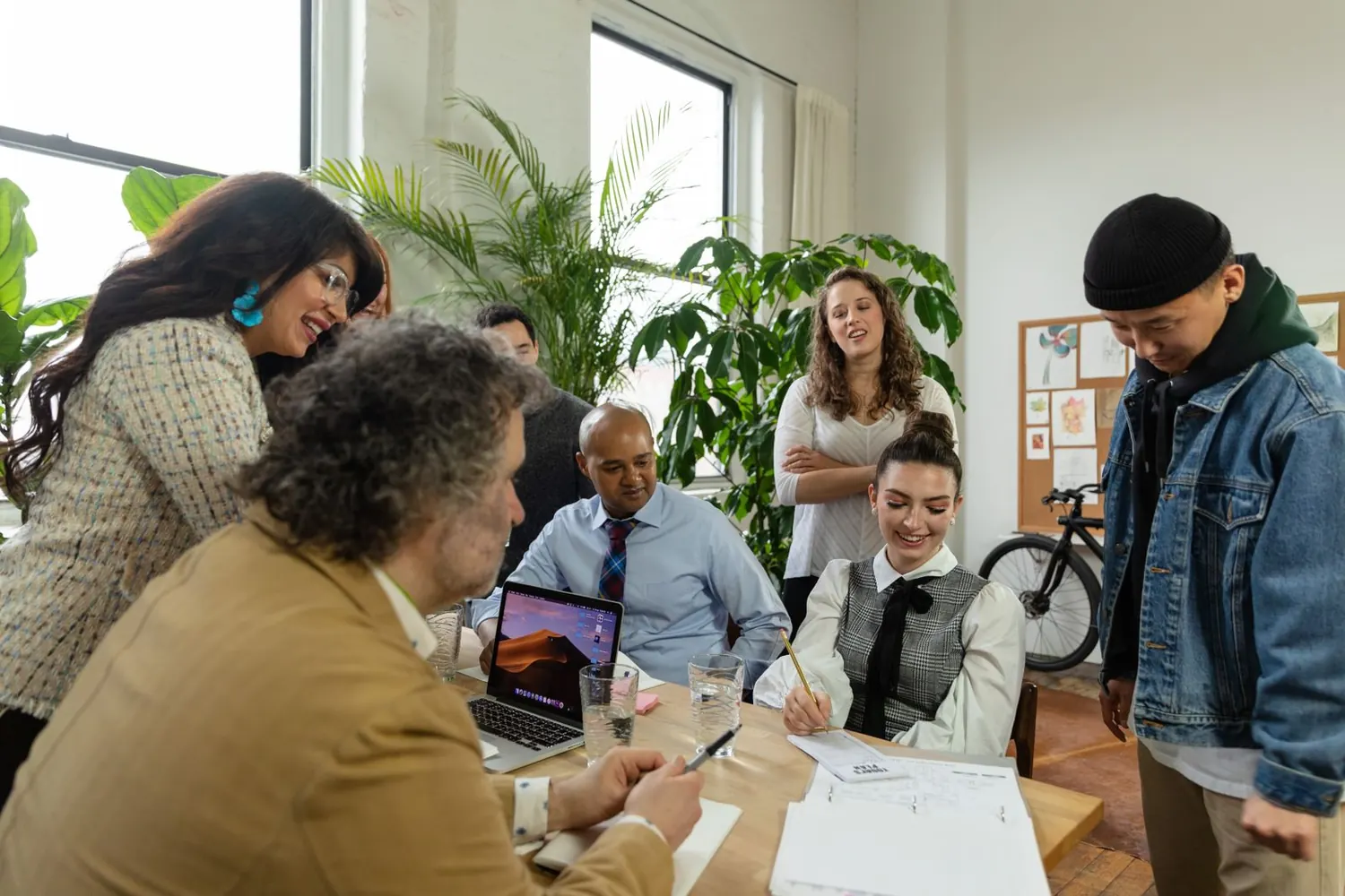 Diverse team discussing a plan around a table